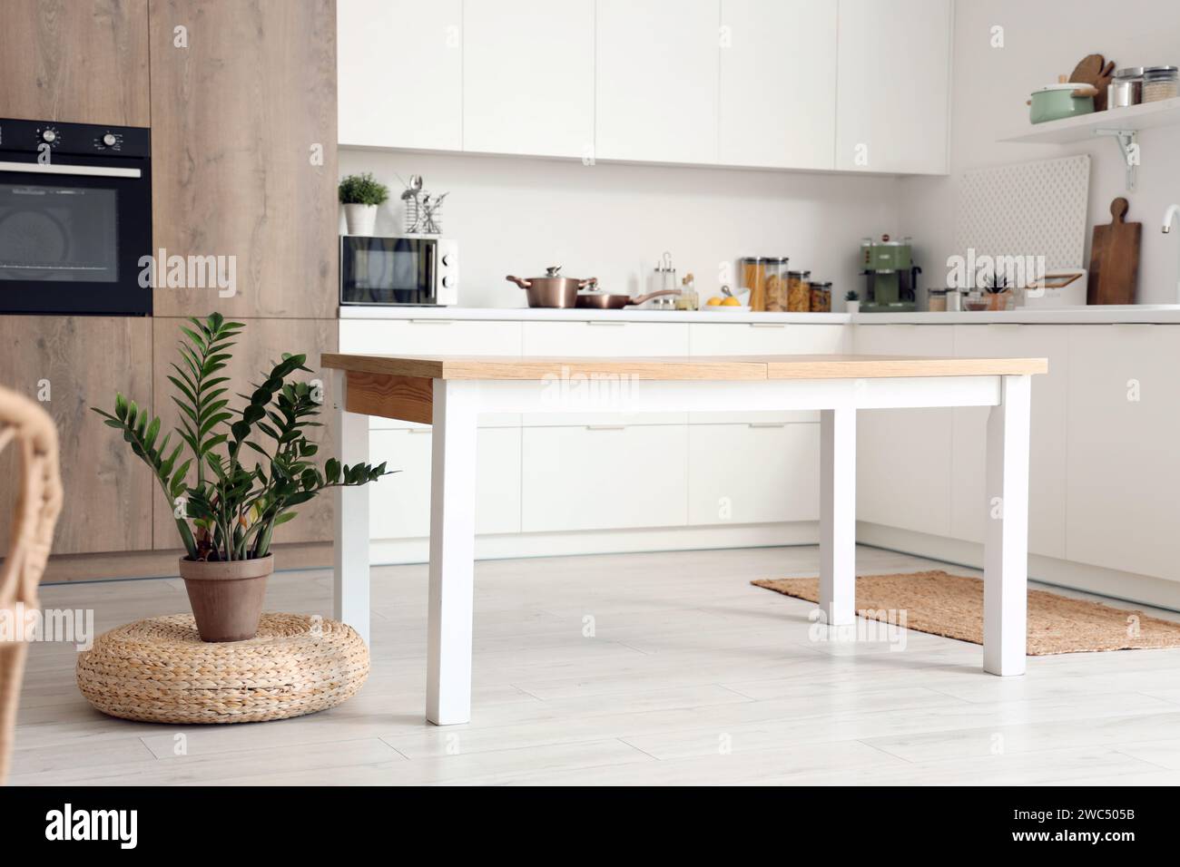 Clean wooden table in interior of modern kitchen Stock Photo - Alamy
