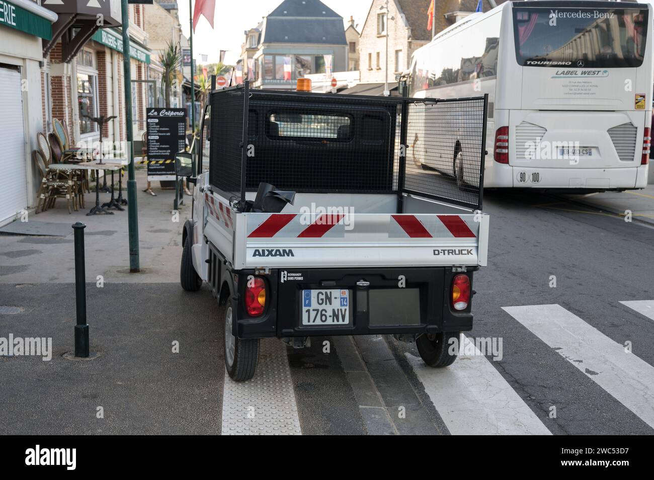 A back view of the small Aixam D-Truck pickup truck of the French city hall for cleaning and maintenance Stock Photo