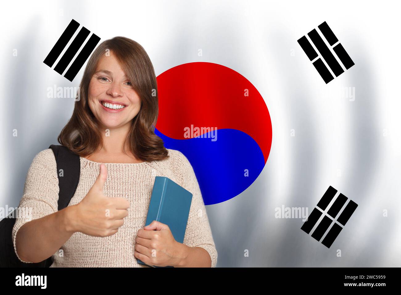 Happy woman student against Korean flag background. Travel, education and learn language in South Korea concept Stock Photo