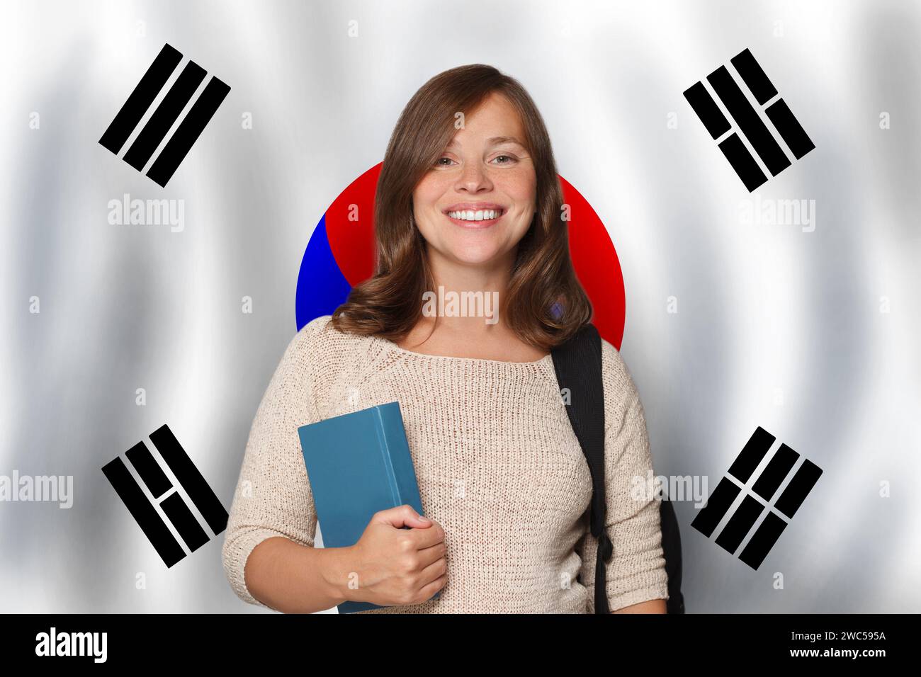 Attractive cheerful woman student against Korean flag background. Travel, education and learn language in South Korea concept Stock Photo