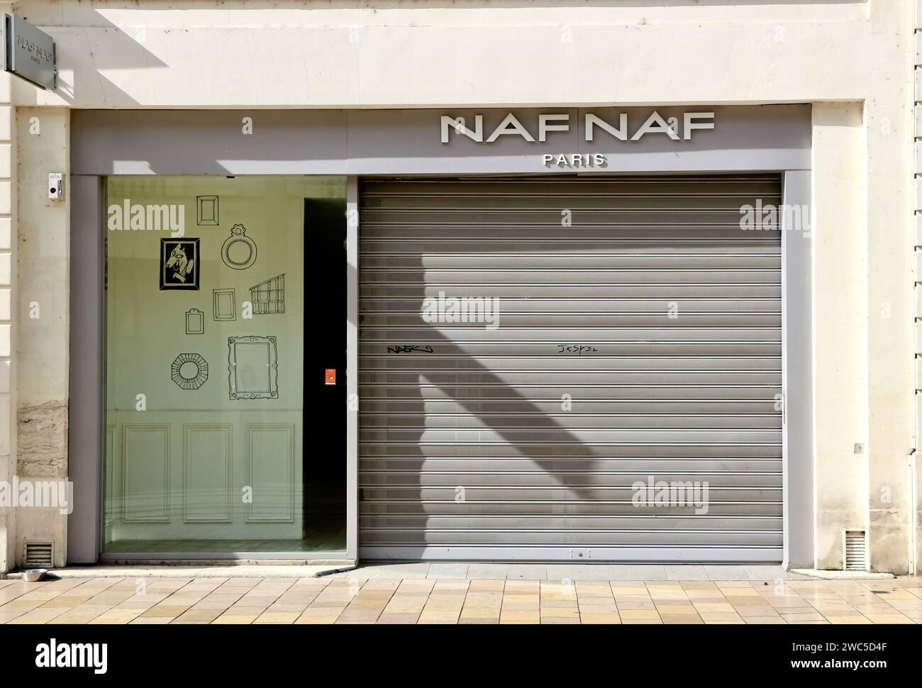 Closed and shuttered Naf Naf womens wear shop entrance on a sunny day Rue Nationale Tours Indre-et-Loire France Stock Photo