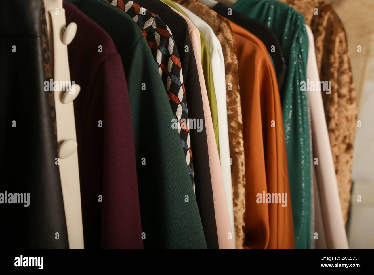 Women's fashion. Different clothes on hangers, close up. Huge selection of different used womens clothes on the rack in a second hand shop or thrift s Stock Photo