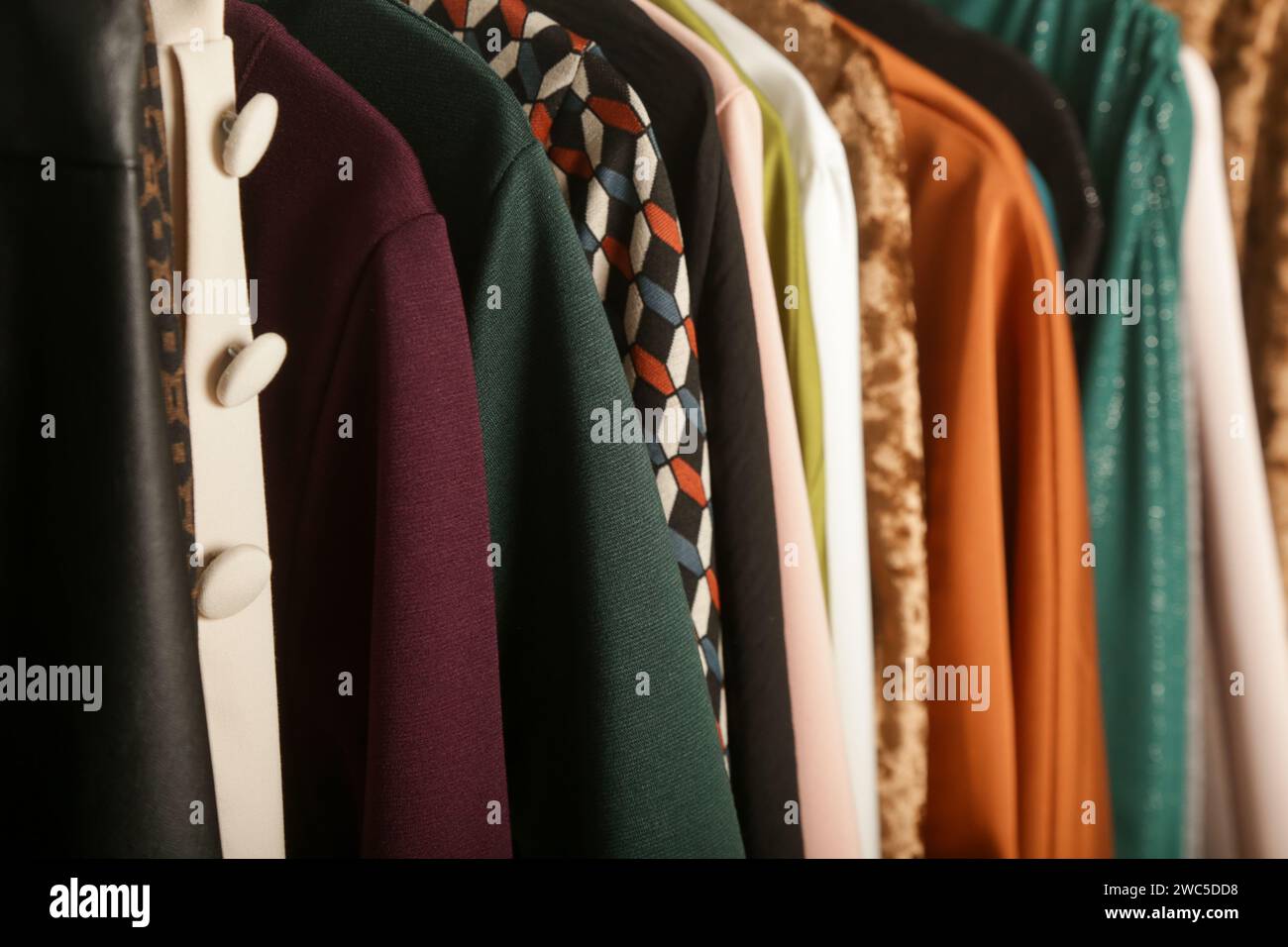 Women's fashion. Different clothes on hangers, close up. Huge selection of different used womens clothes on the rack in a second hand shop or thrift s Stock Photo