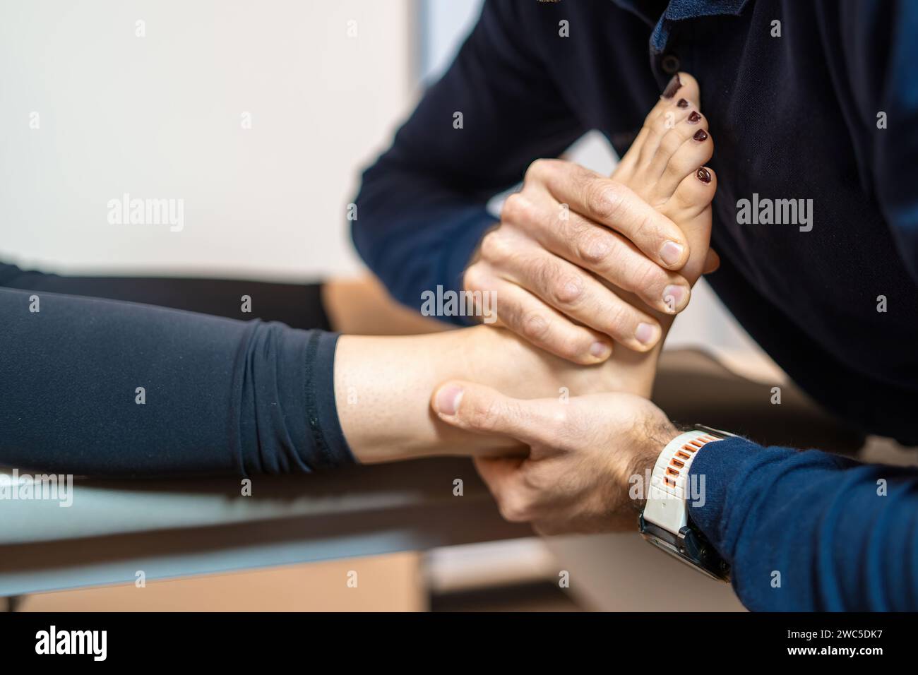 Professional physiotherapist providing manual therapy for foot and