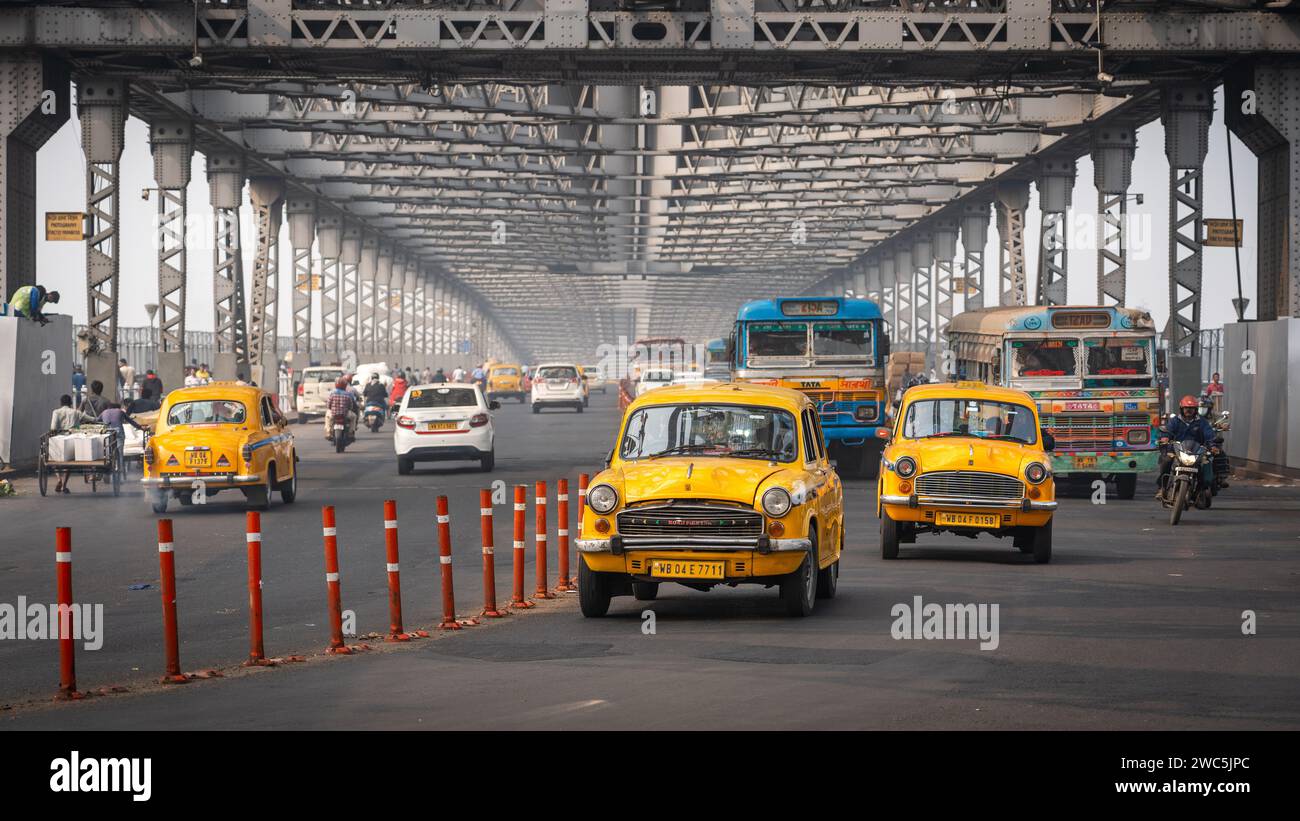 Traffic on the iconic Howrah Bridge, the busiest cantilever bridge in the world, in Kolkata, West Bengal, India. Stock Photo