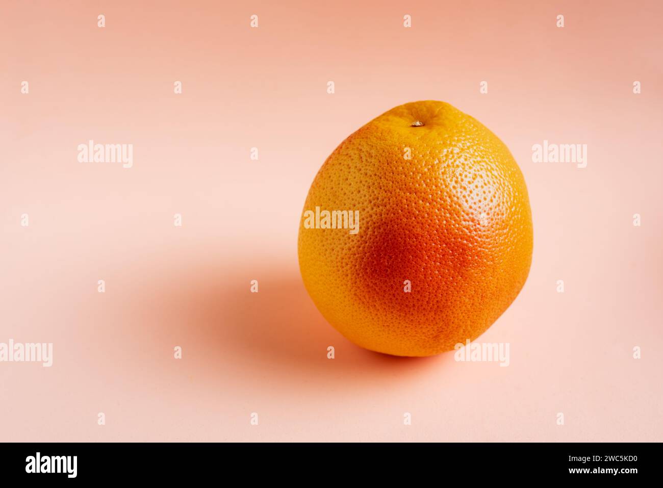 Ripe grapefruit close-up on pink background. Stock Photo