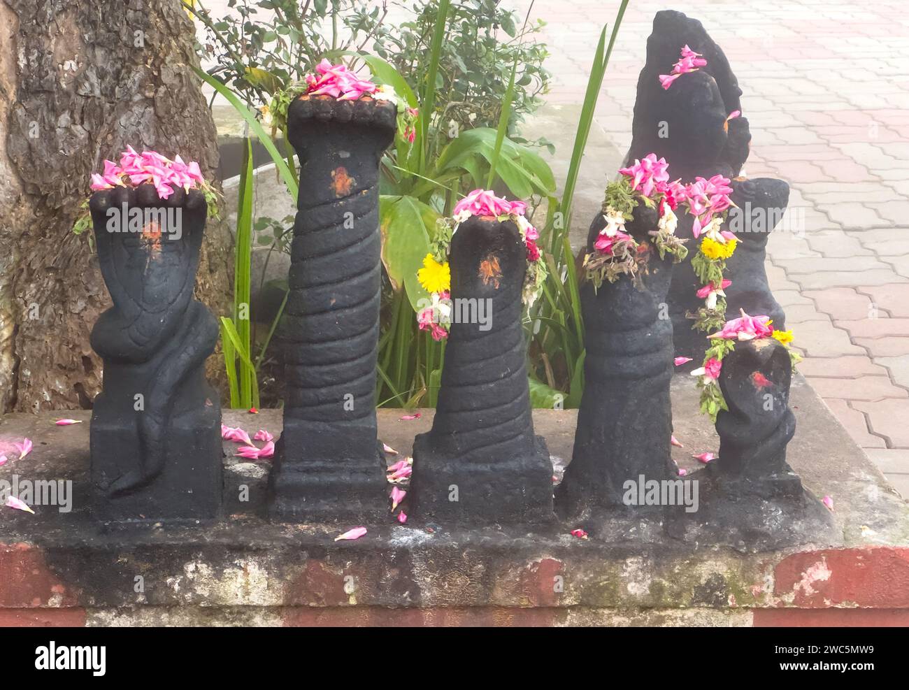 Snake gods at the Kuzhanthai Velapar Temple (means baby lord murugan temple) with flowers worshipped by devotees Stock Photo
