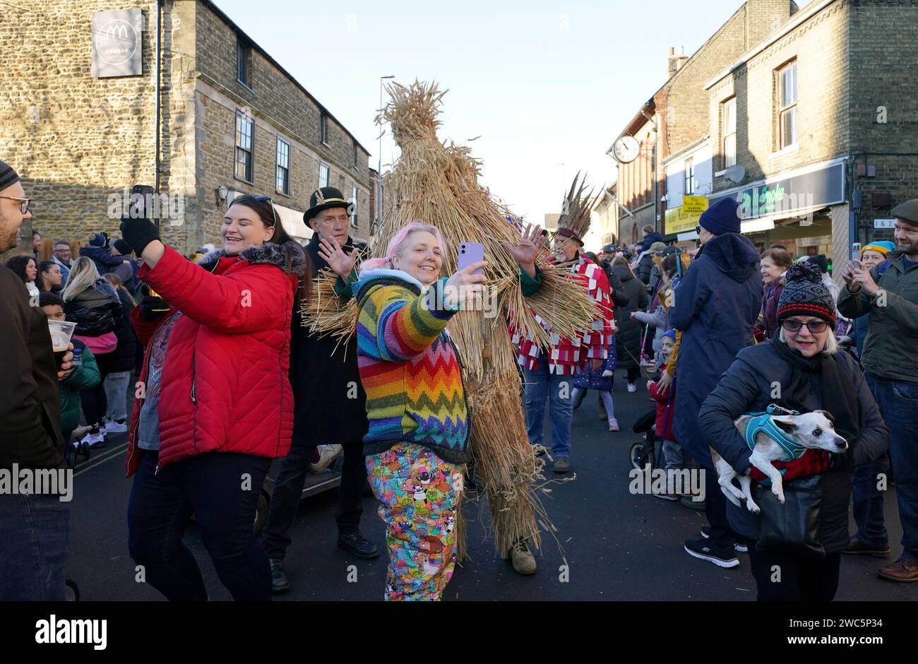 Red Leicester Morris dancers perform as the Straw Bear is paraded