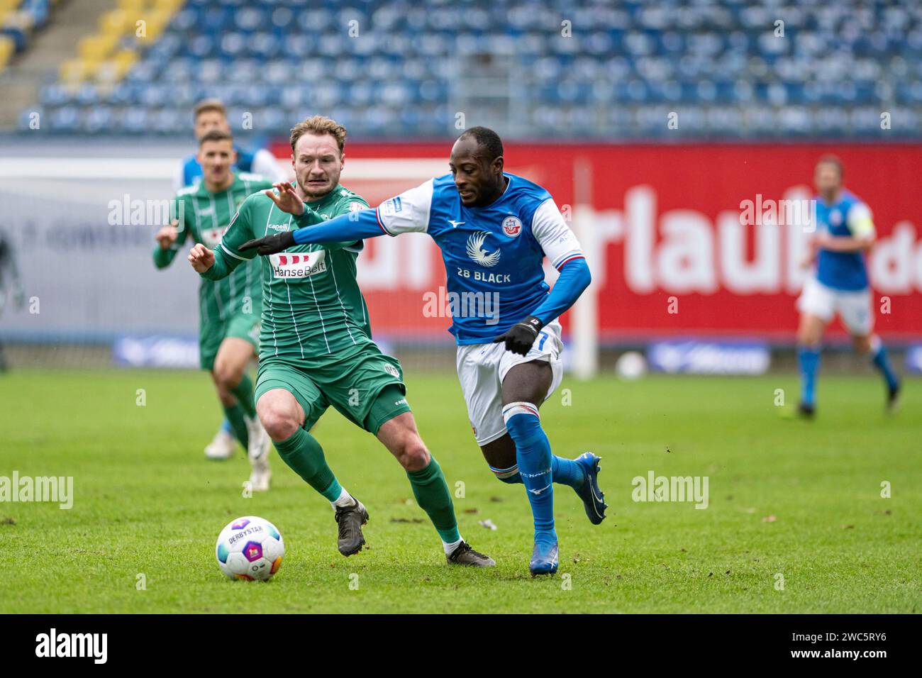 Rostock, Deutschland 14. Januar 2024: Testspiel - 2023/2024 - FC Hansa Rostock vs. VfB Lübeck Im Bild: v. li. im Zweikampf Florian Egerer (VfB Lübeck) und Christian Kinsombi (Hansa Rostock) Stock Photo