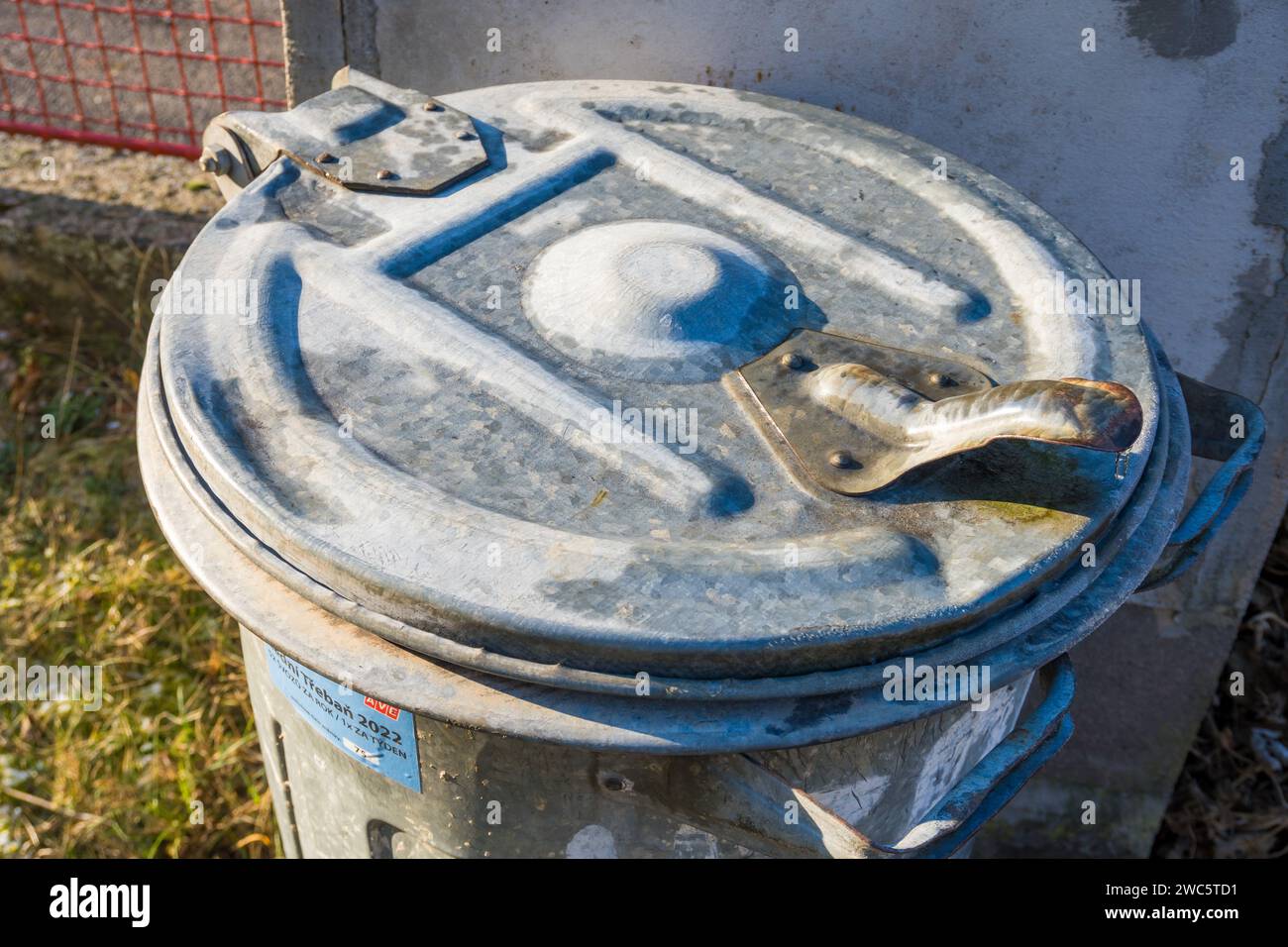 Metal Trash Can With Snow On Top Of Trash Can Lid. closeup Stock Photo