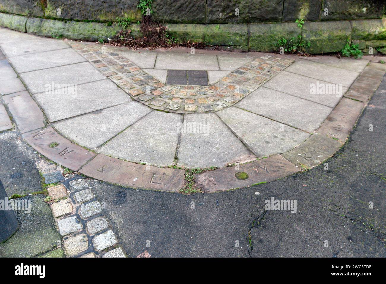 Inscrpition in the pavement on Deepdale Road. Preston. Initials of the LNWR and L&YR, on the former Preston to Longridge Railway. Stock Photo
