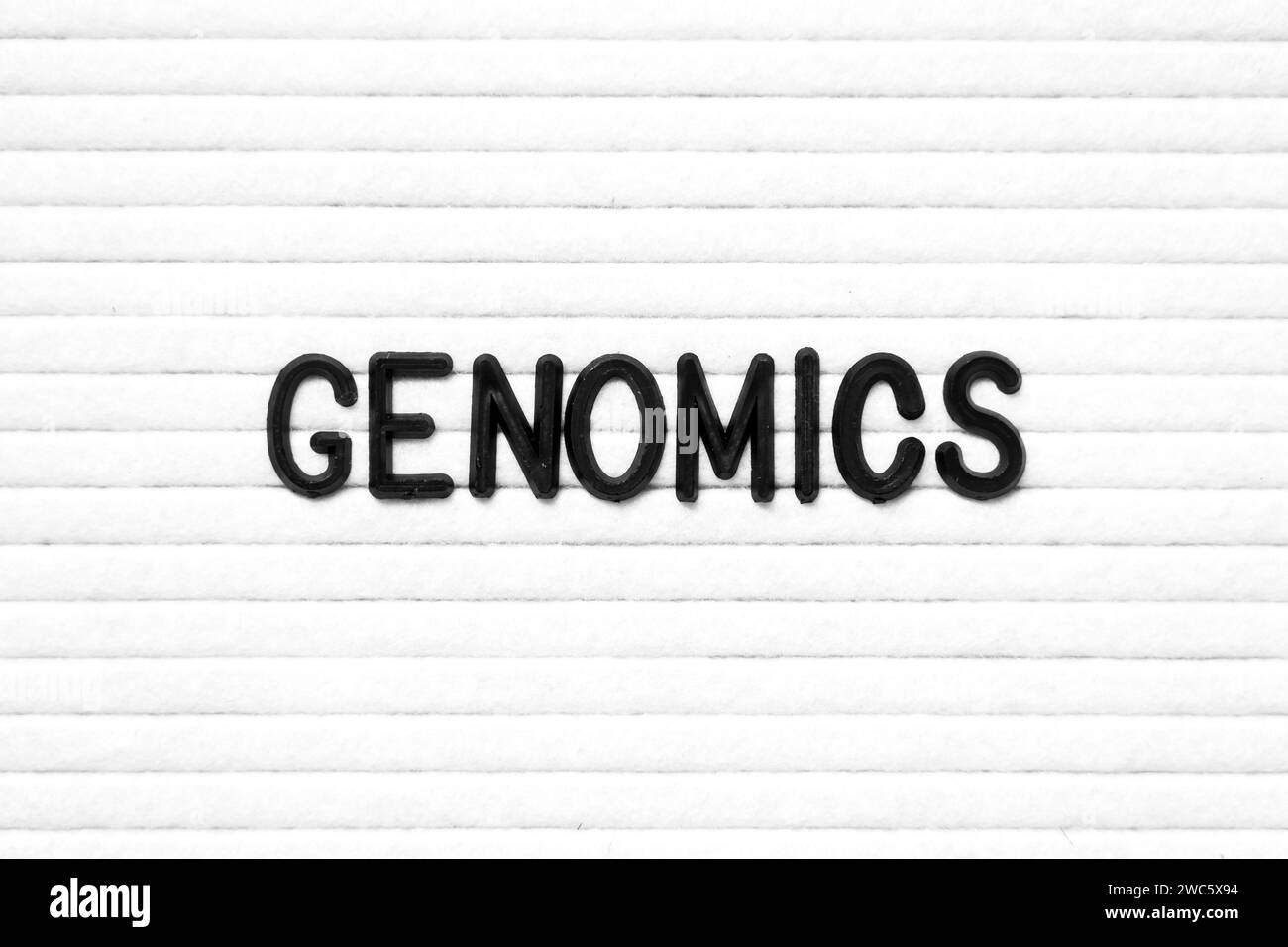 Black color letter in word genomics on white felt board background Stock Photo
