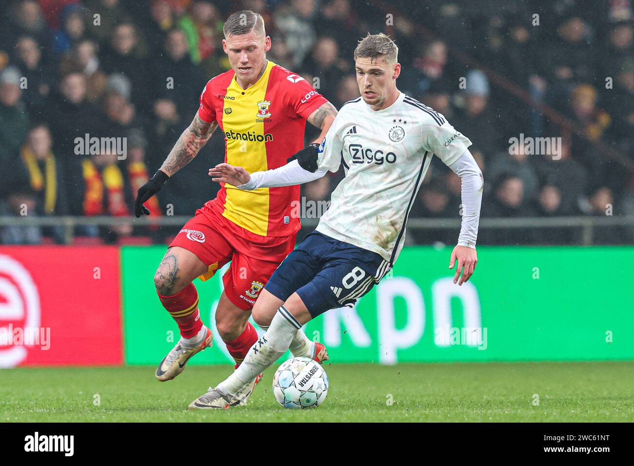 DEVENTER, NETHERLANDS - JANUARY 14: Oliver Edvardsen of Go Ahead Eagles, Kenneth Taylor of AFC Ajax battle for the ball during the Dutch Eredivisie match between Go Ahead Eagles and AFC Ajax at De Adelaarshorst on January 14, 2024 in Deventer, Netherlands. (Photo by Peter Lous/Orange Pictures) Stock Photo