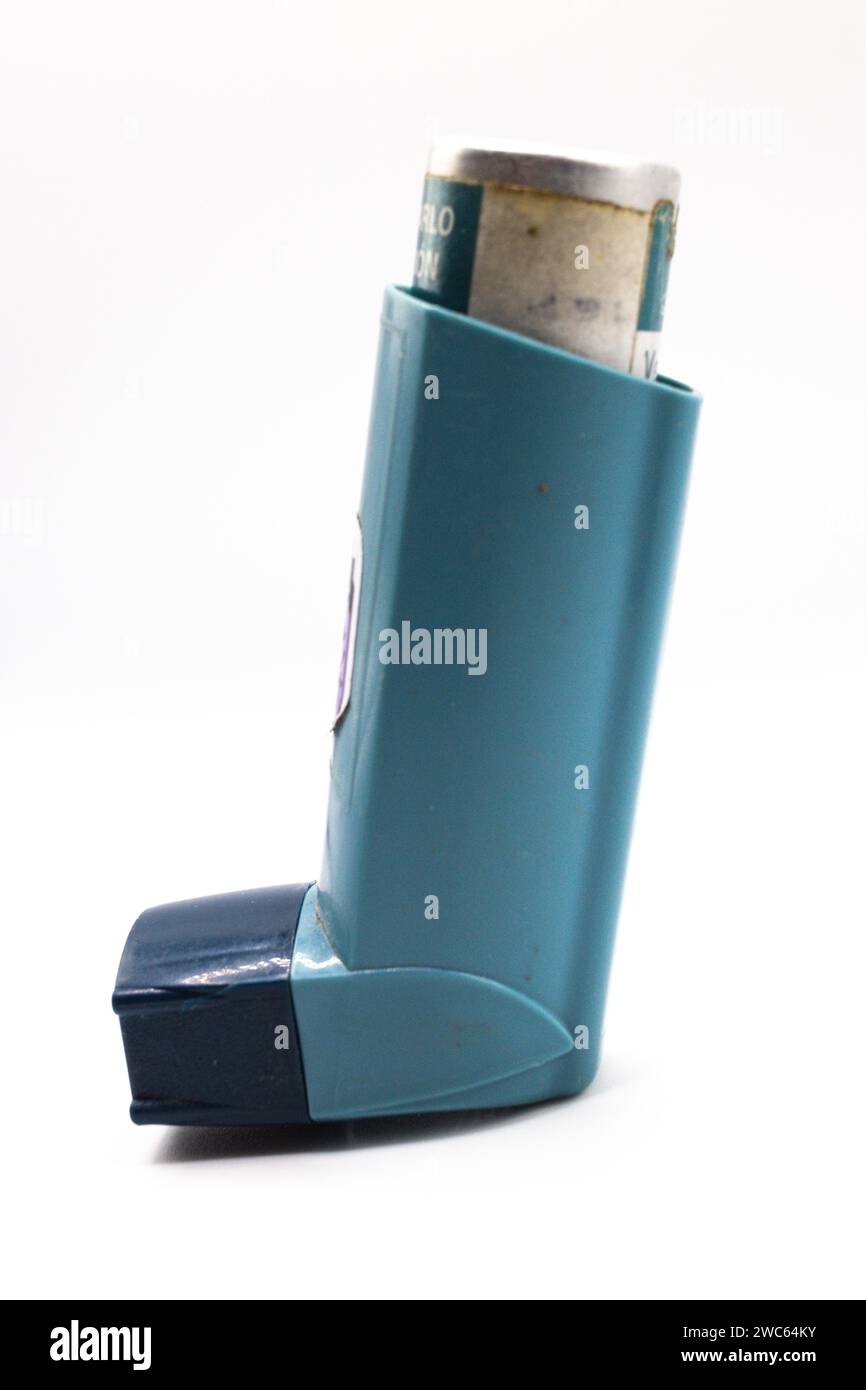 Asthmatic inhaler isolated. Medical asthma inhaler with cap on isolated