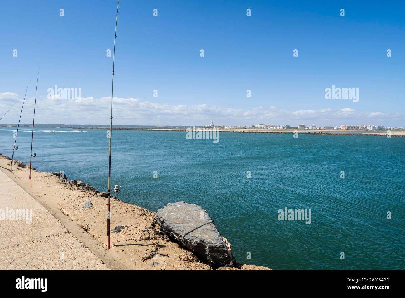 Fishing from the pier on Atlantic Ocean in Isla Canela in Andalusia, southern Spain Stock Photo