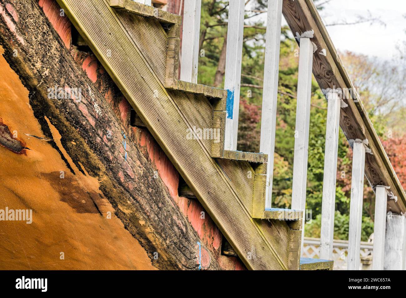 Closeup of wooden outdoor staircase on old abandoned building Stock Photo