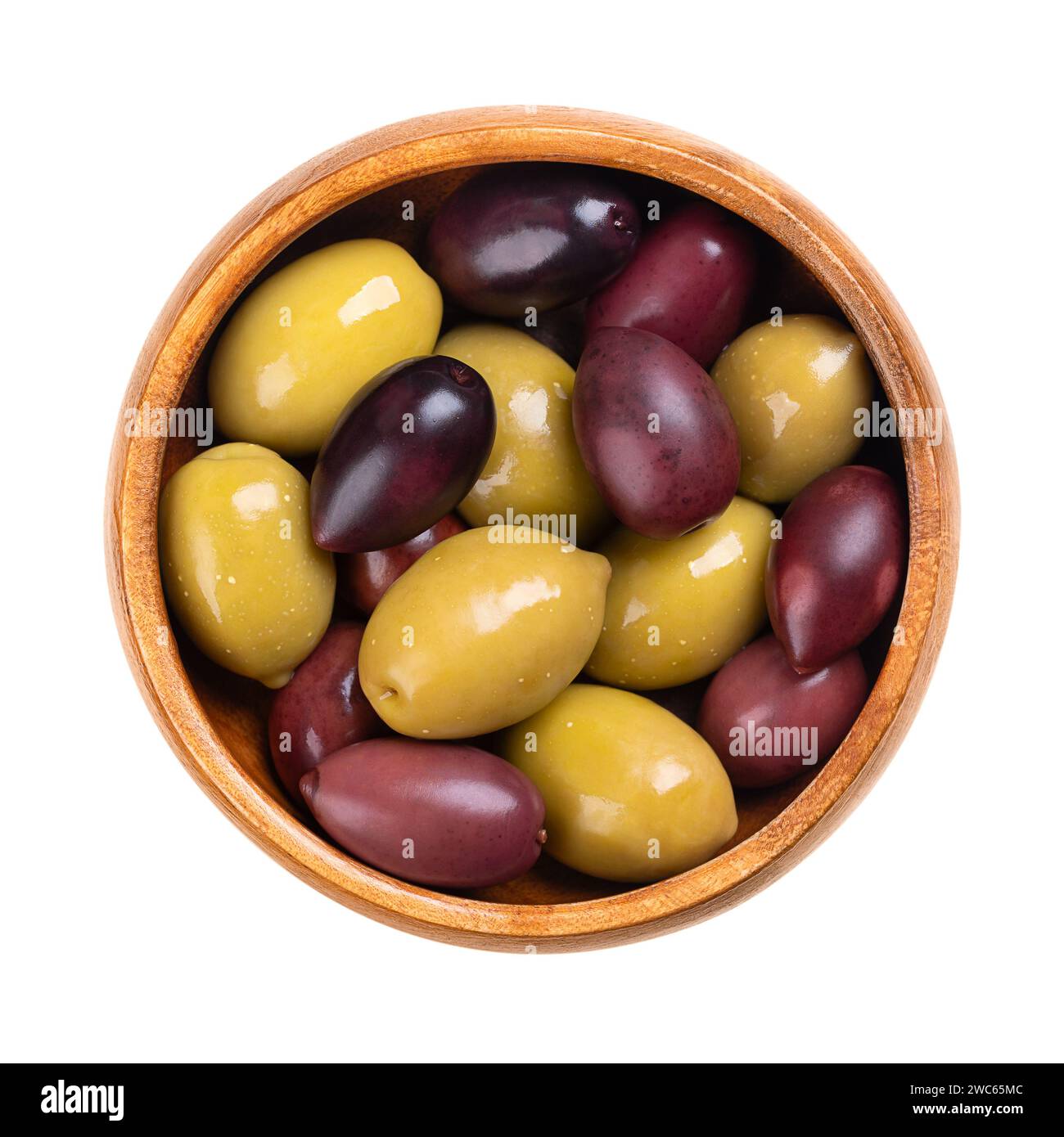 Kalamata and green olives with pit, pickled whole, large Greek table olives, in a wooden bowl. Stock Photo