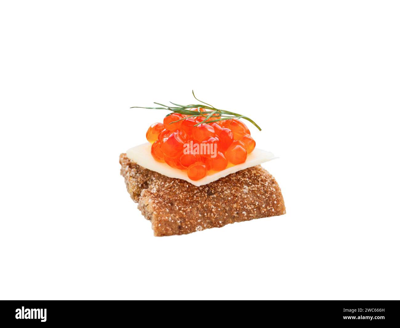 Salmon roe canape with dill branch isolated on white. Red caviar and butter on the wholegrain bread.  Fish eggs sandwich for party buffet. Mini toast. Stock Photo