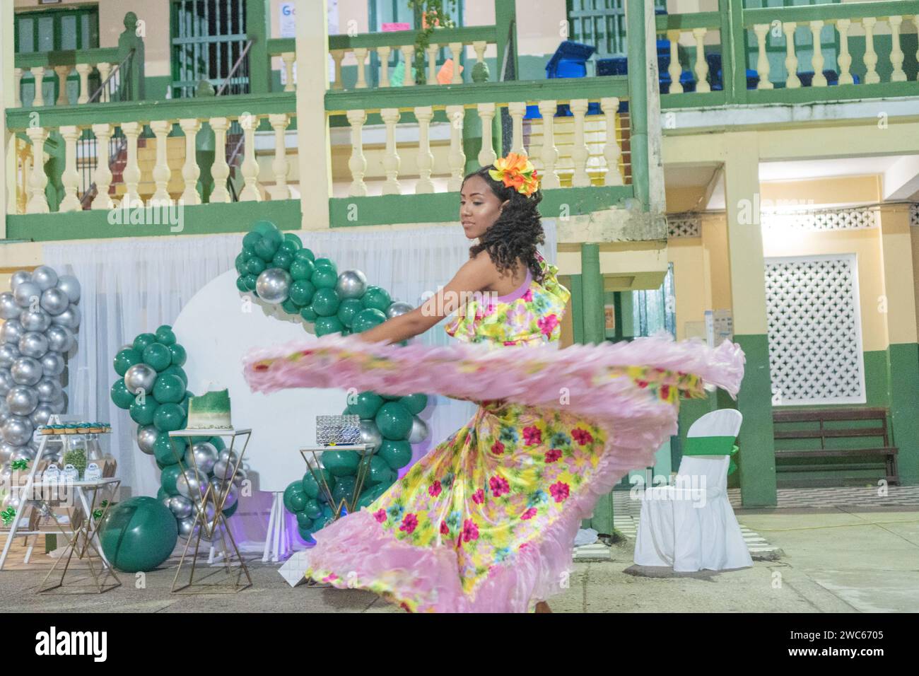 A woman captured mid-twirl in a traditional Cumbia dance, adorned with