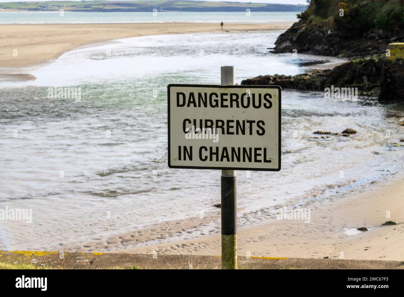 Dangerous Current Warning Sign next to tidal creek Stock Photo