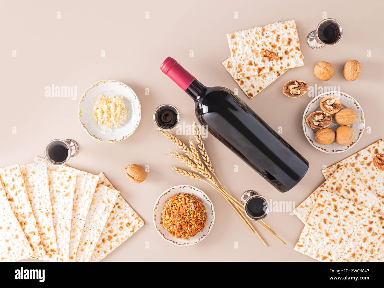 matzoth, bottle of kosher wine, a silver cup with wine, walnuts, fruit