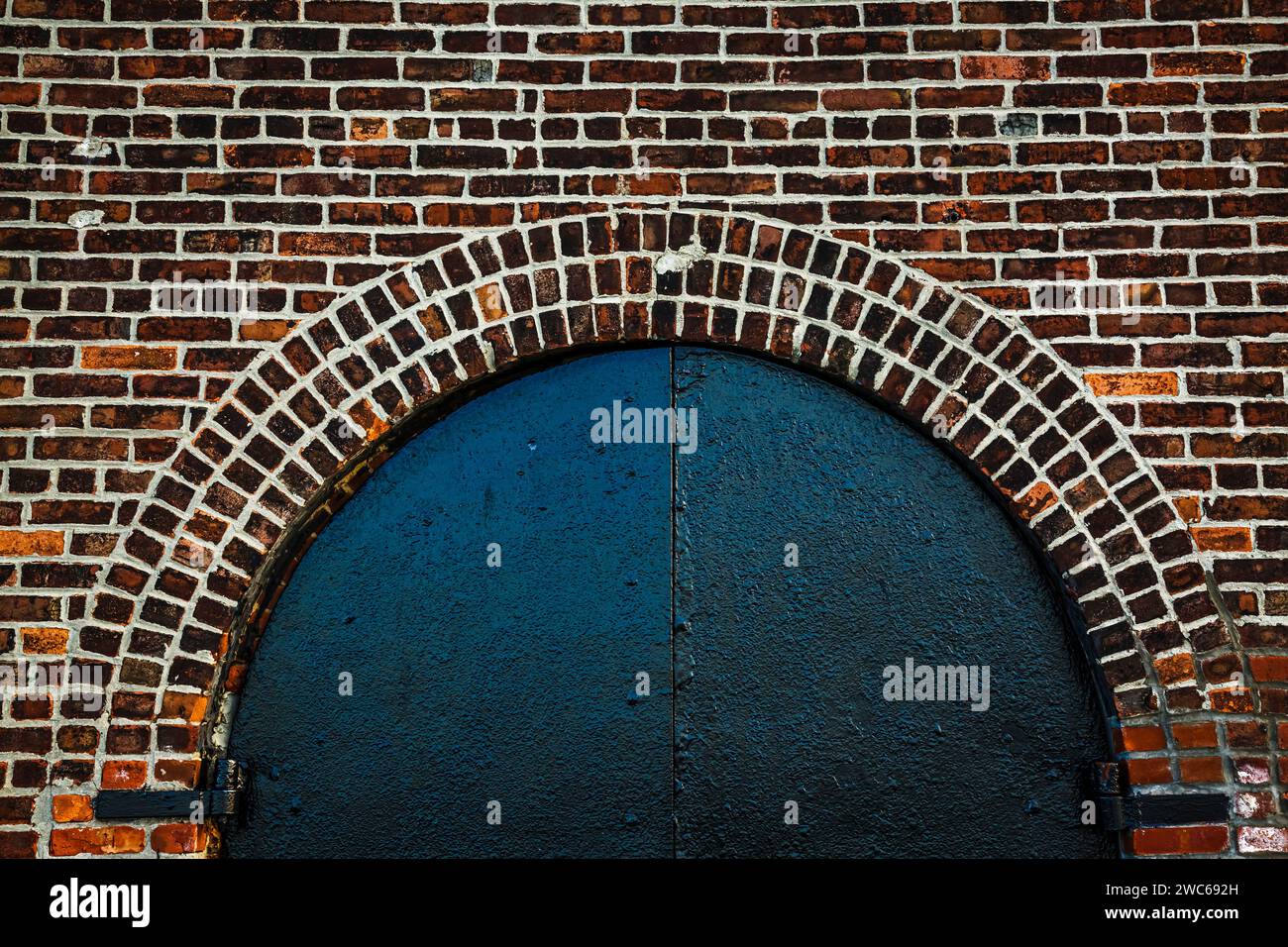 Detail of black door arch on brickwall in Red Hook, Brooklyn, New York Stock Photo