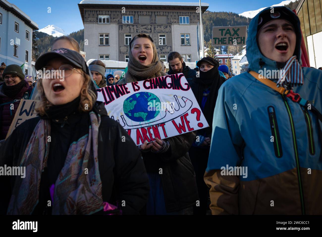 Davos, Switzerland. 14th Jan, 2024. Davos, CH 14 January, 2024. Protesters with placards hike to Davos to protest the 54th World Economic Forum. Hundreds of protesters gathered to voice concerns about this year's WEF agenda. The Forum engages society's political, business, and cultural leaders to shape global, regional, and industry agendas, which can impact everyone around the world. Credit: Andy Barton/Alamy Live News Stock Photo