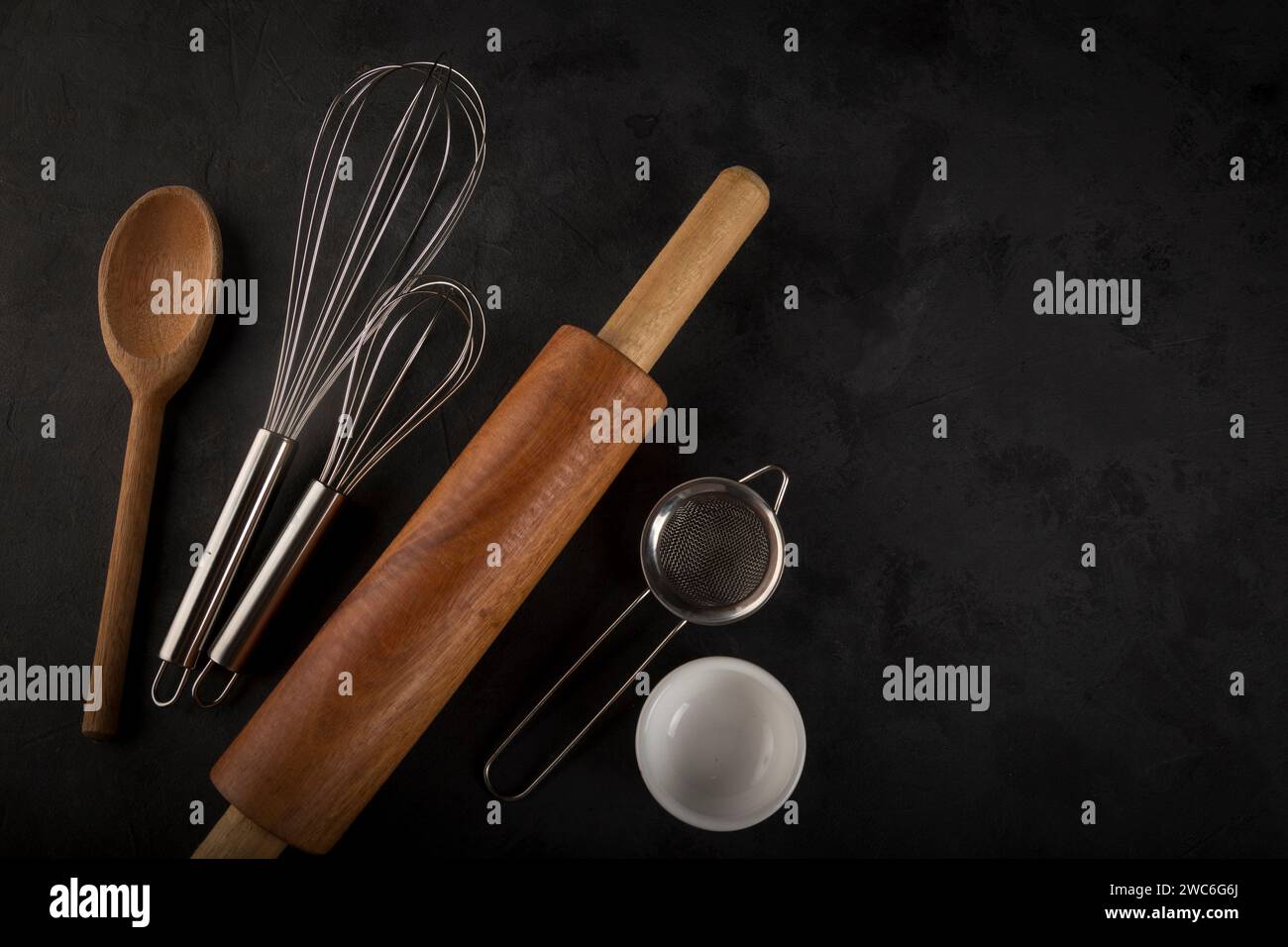 kitchen utensils on black background, seen from above. Stock Photo