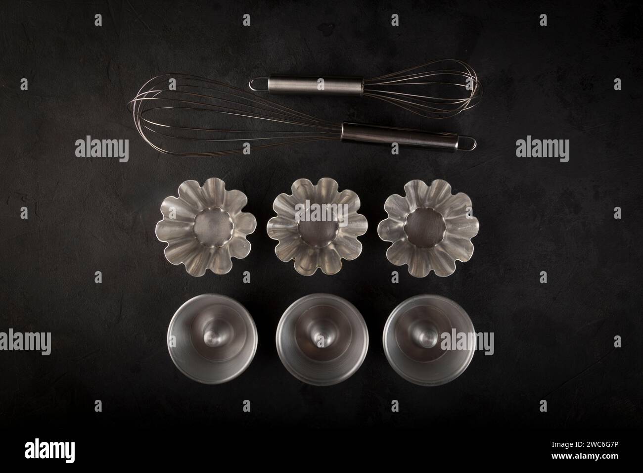 kitchen utensils on black background, seen from above. Stock Photo