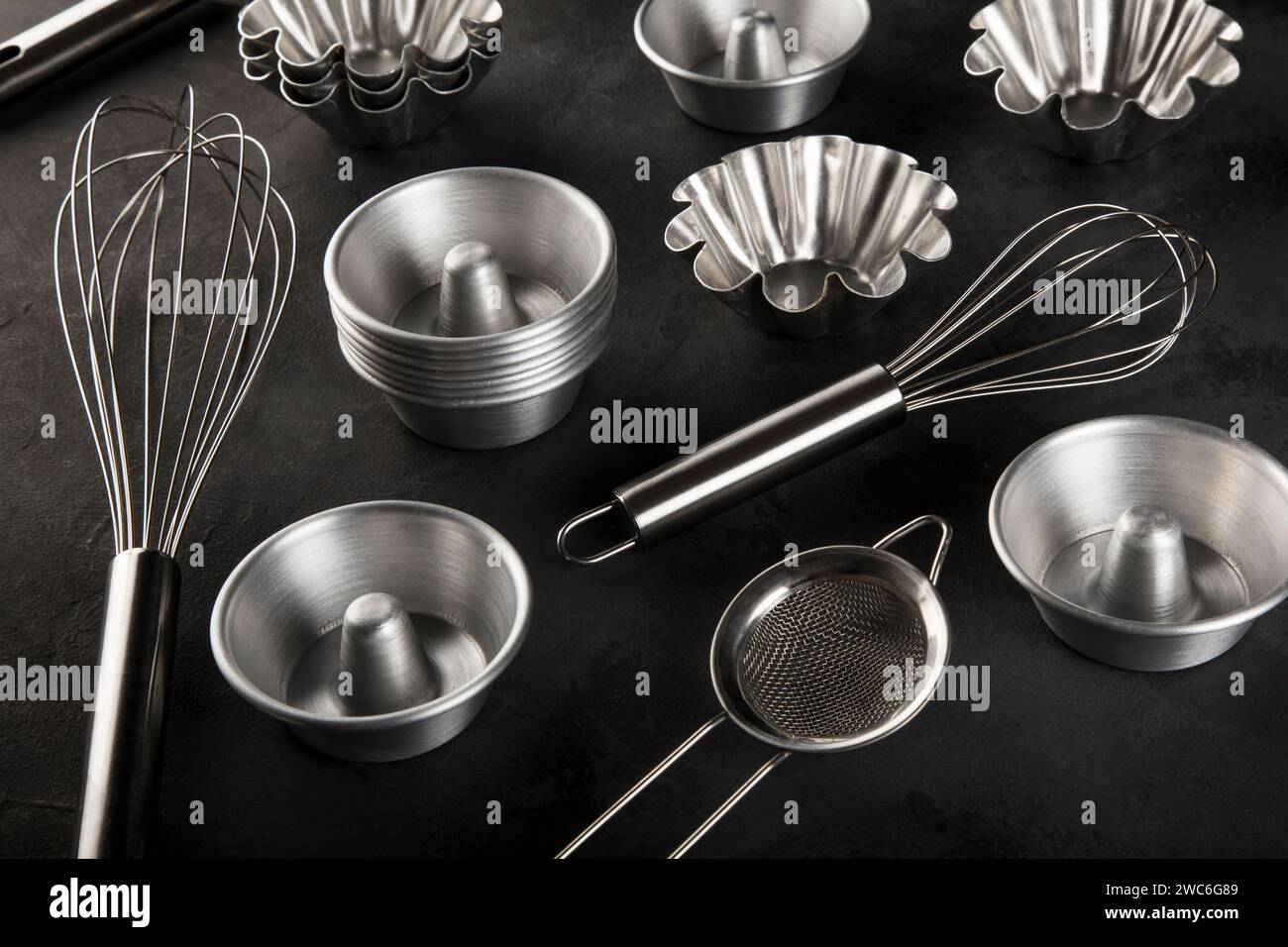 kitchen utensils on black background, seen from above. Stock Photo