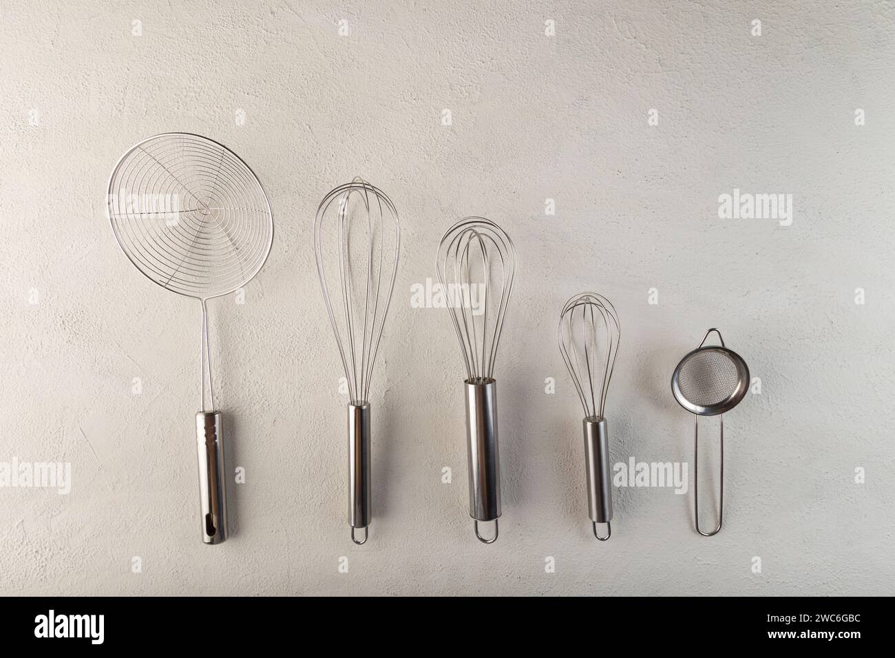 kitchen utensils on light background, seen from above. Stock Photo