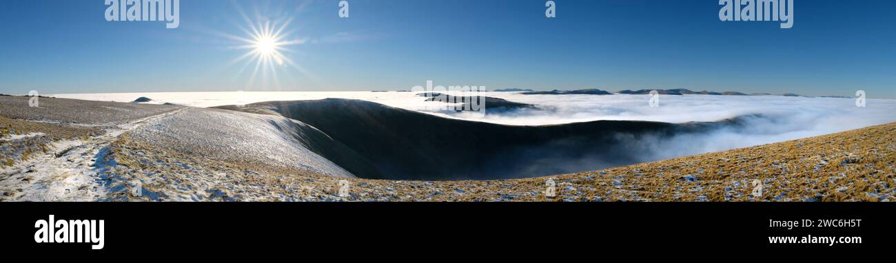 A panoramic view of the Lake District fells above a cloud inversion Stock Photo