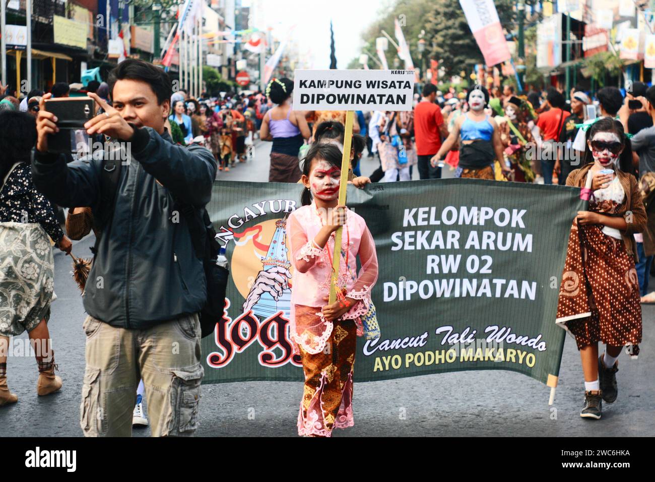 Local tourist take selfie on culture carnival festival in malioboro street, Yogyakarta. Stock Photo