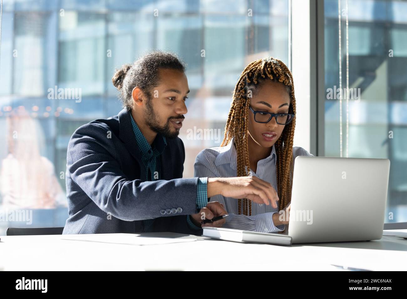 Confident black man mentor teach biracial woman intern at workplace ...