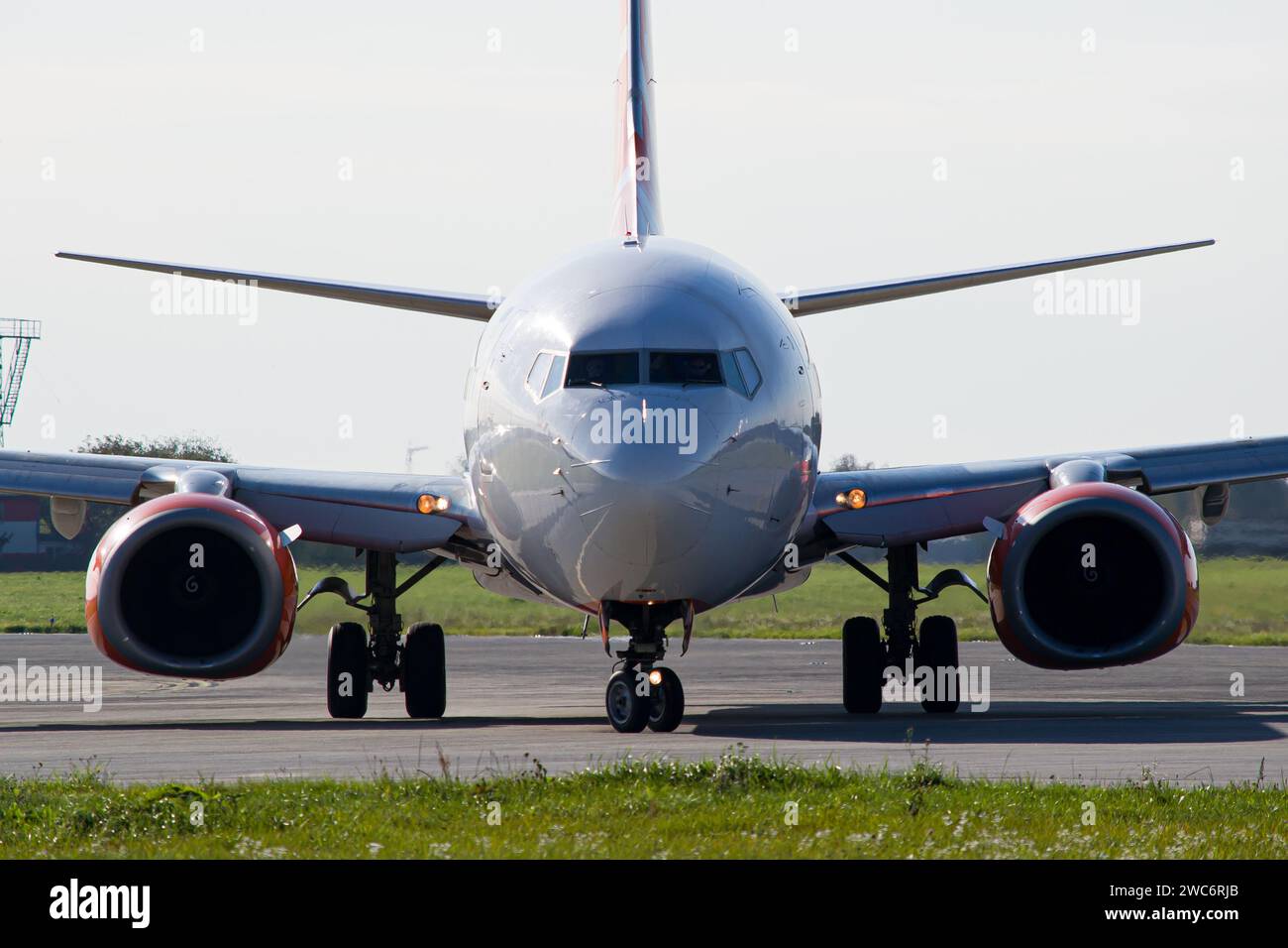 Face-to-face colse-up photo of a passenger commercial aircraft turning around on the runway before takeoff Stock Photo