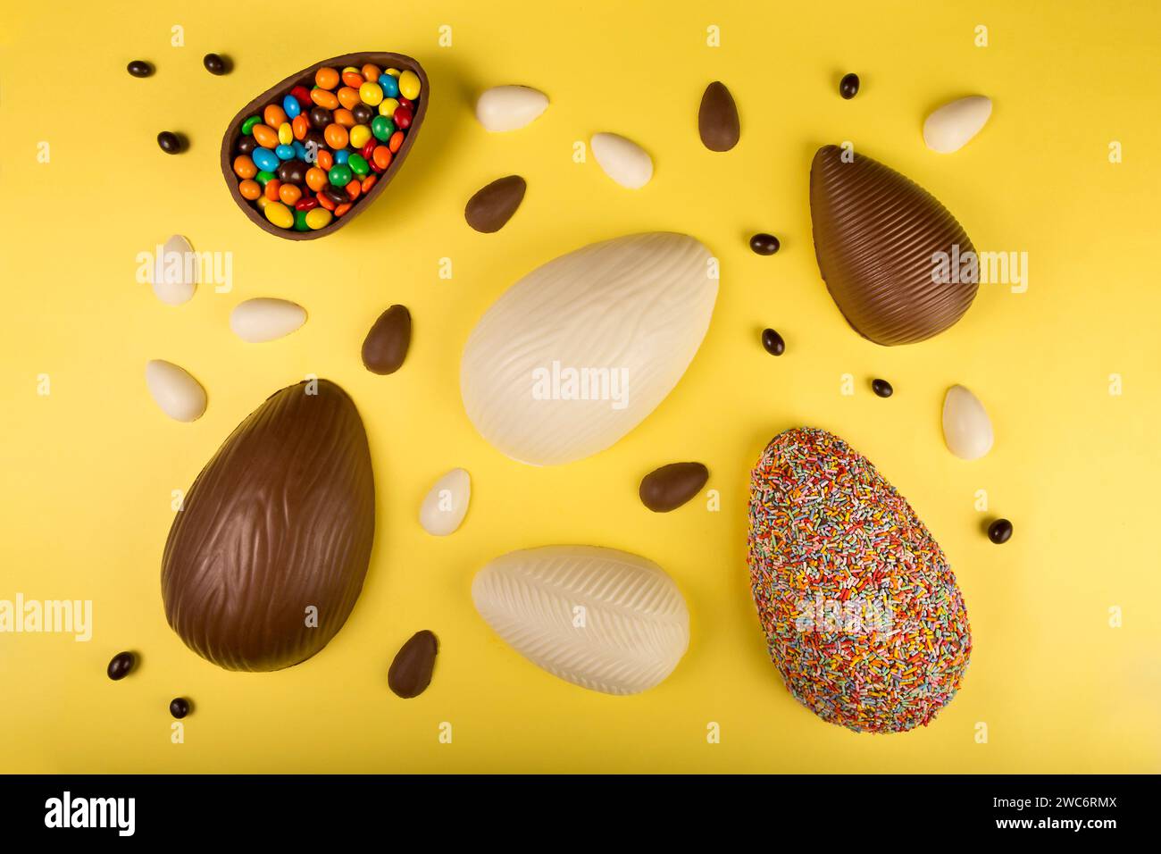 Easter. Composition with chocolate easter eggs on yellow background. Stock Photo