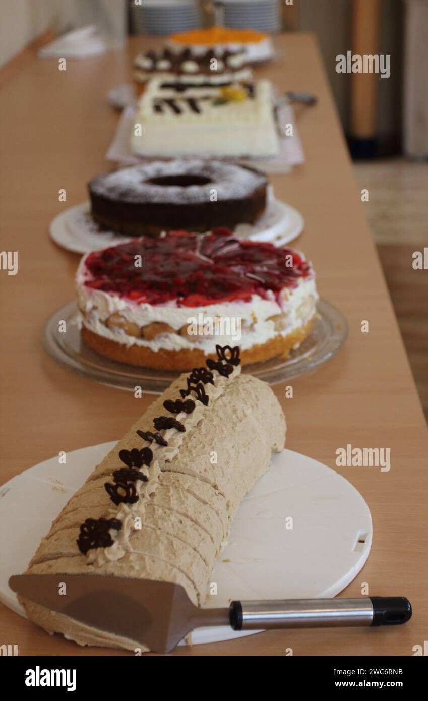 One with various cakes, festively set up dinner table Stock Photo