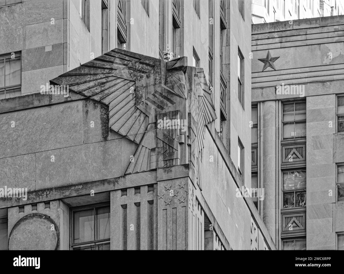 Massive Art Deco-styled limestone eagles decorate the corners of the Federal Office Building adjacent to the NYC World Trade Center complex. (B/W) Stock Photo