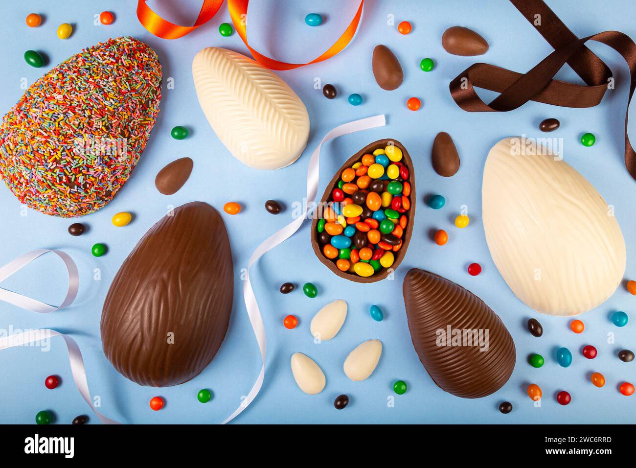 Easter. Composition with chocolate easter eggs on blue background. Stock Photo