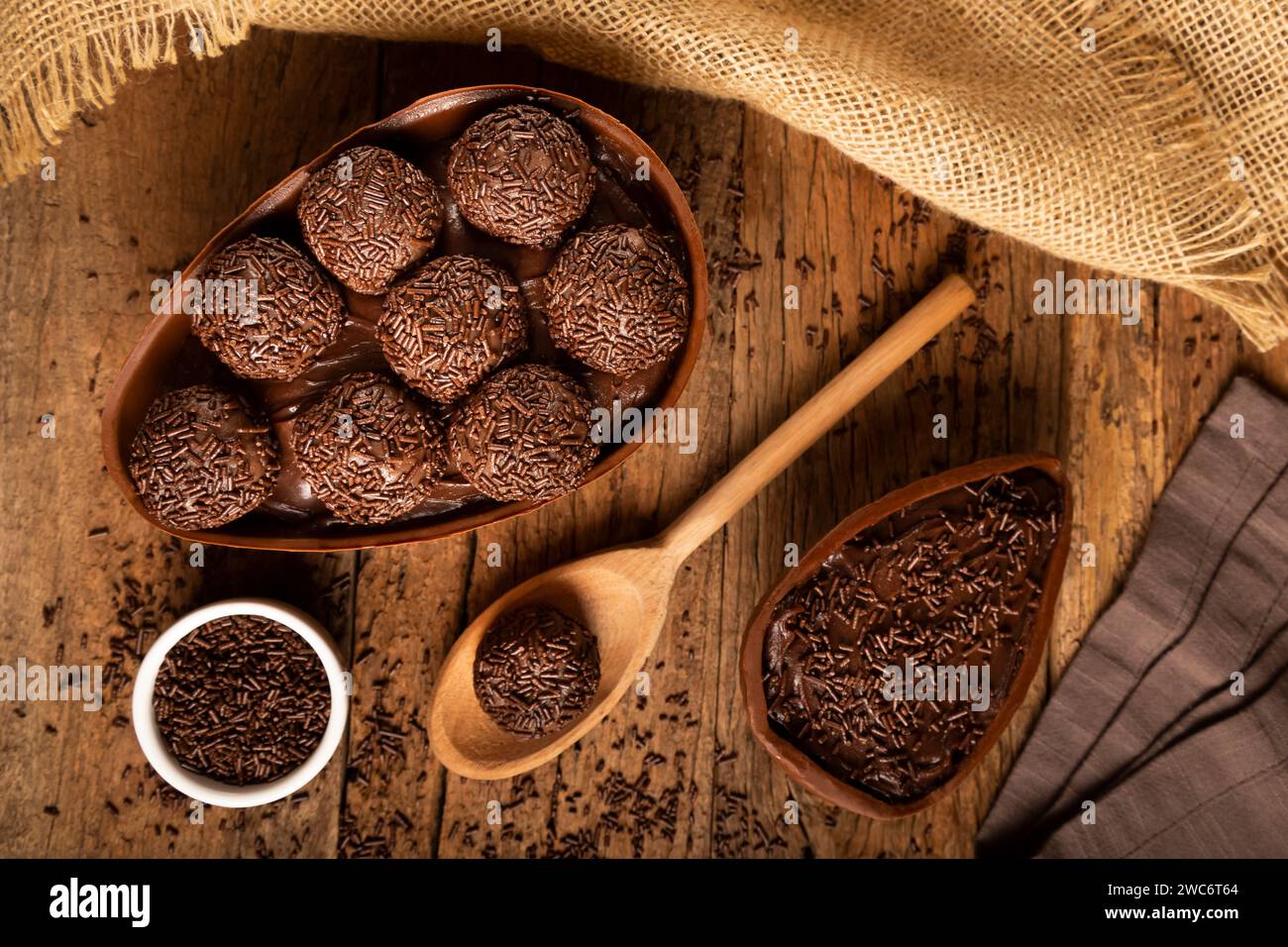 Chocolate Easter eggs stuffed with brigadiers on rustic wooden background. Stock Photo