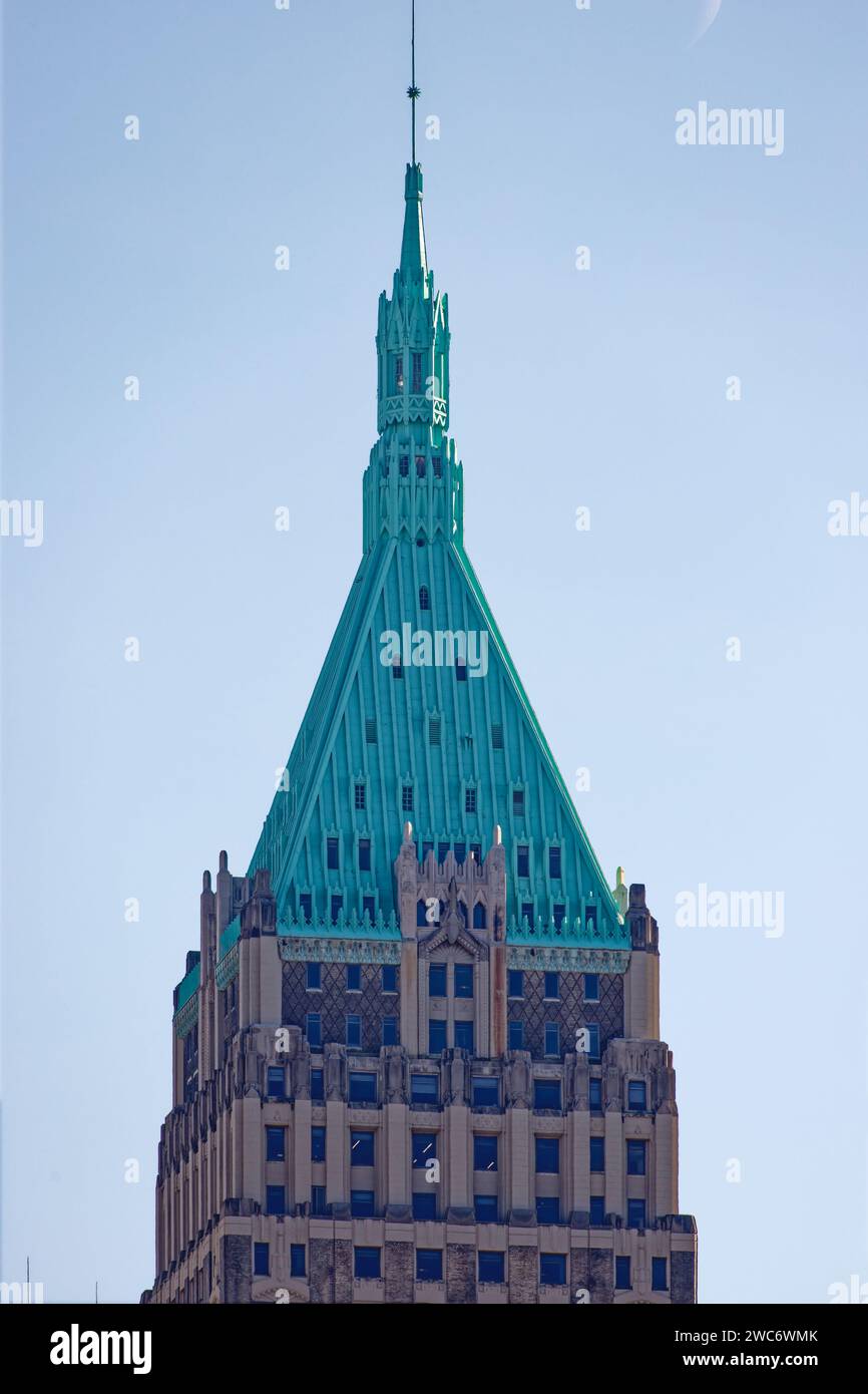 A verdigris pyramid and cupola marks 40 Wall Street, an historic landmark skyscraper, renamed Trump Building, in NYC’s Financial District. Stock Photo