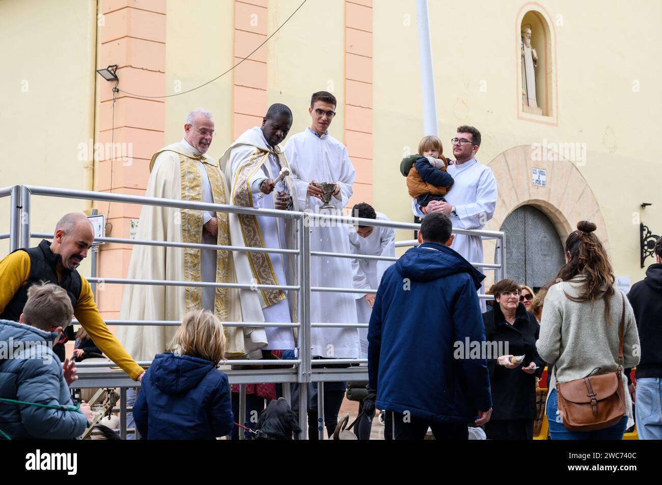 Celebration of St. Anthony's Day with the blessing of the animals by the priests in the street in front of the church, in Alginet, Valencia, Spain Stock Photo