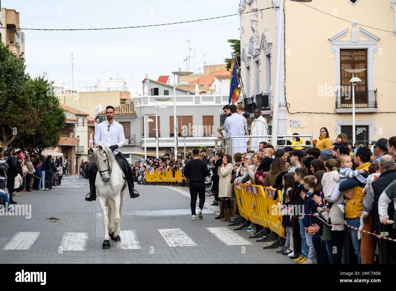 Celebration of St. Anthony's Day with the blessing of the animals by the priests in the street in front of the church, in Alginet, Valencia, Spain Stock Photo