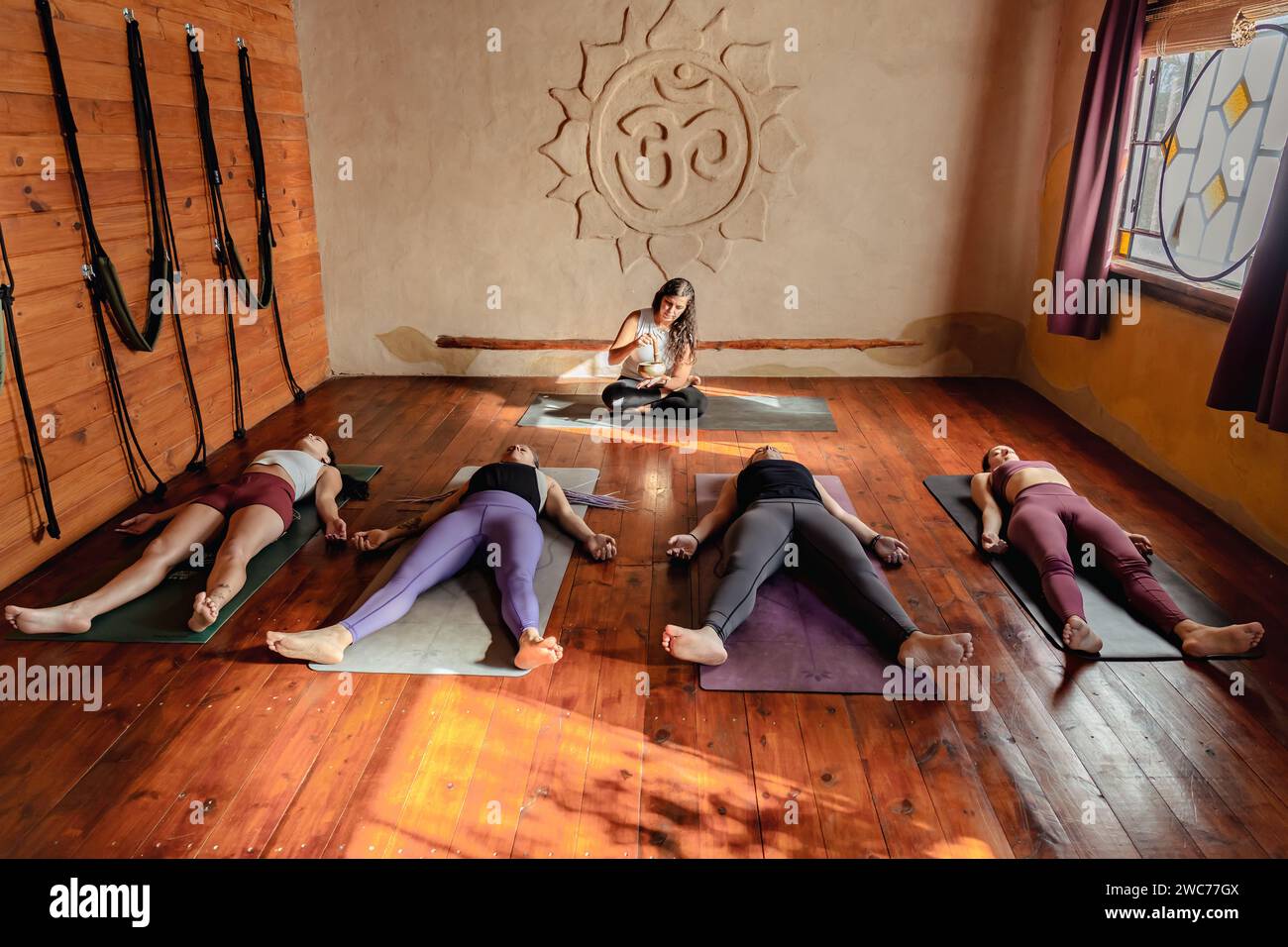 Yoga class lying down in in Corpse pose. Shavasana at end of class