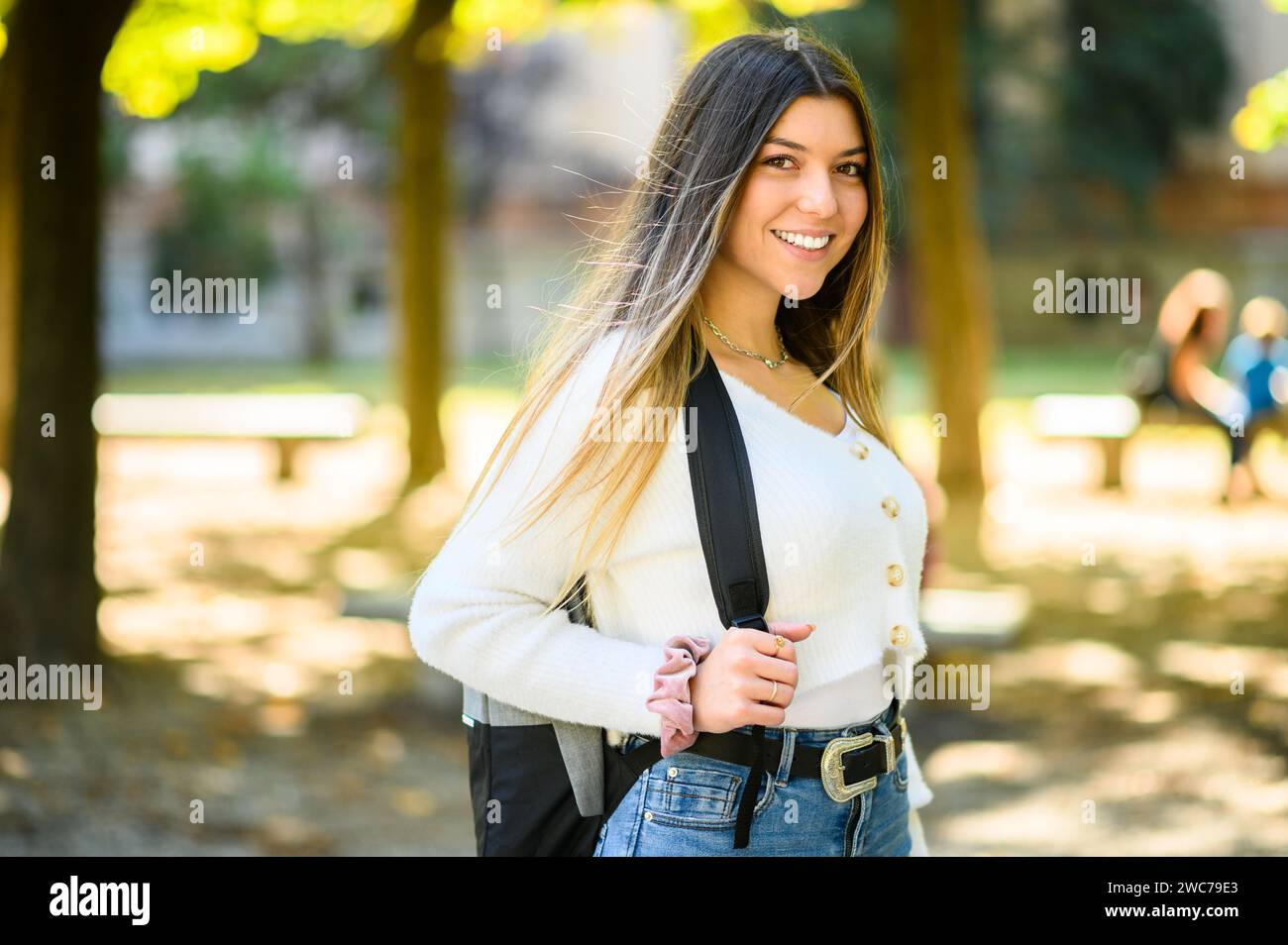 Female student holding walking outdoor in the park and smiling Stock Photo