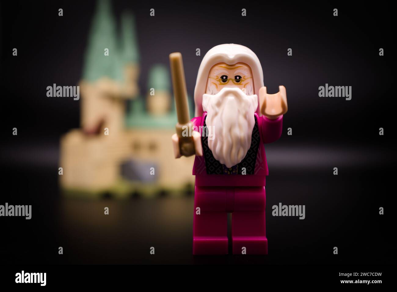 Dumbledore in front of Hogwarts Castle. Lego minifigure and all other bricks are made by THE LEGO GROUP Stock Photo
