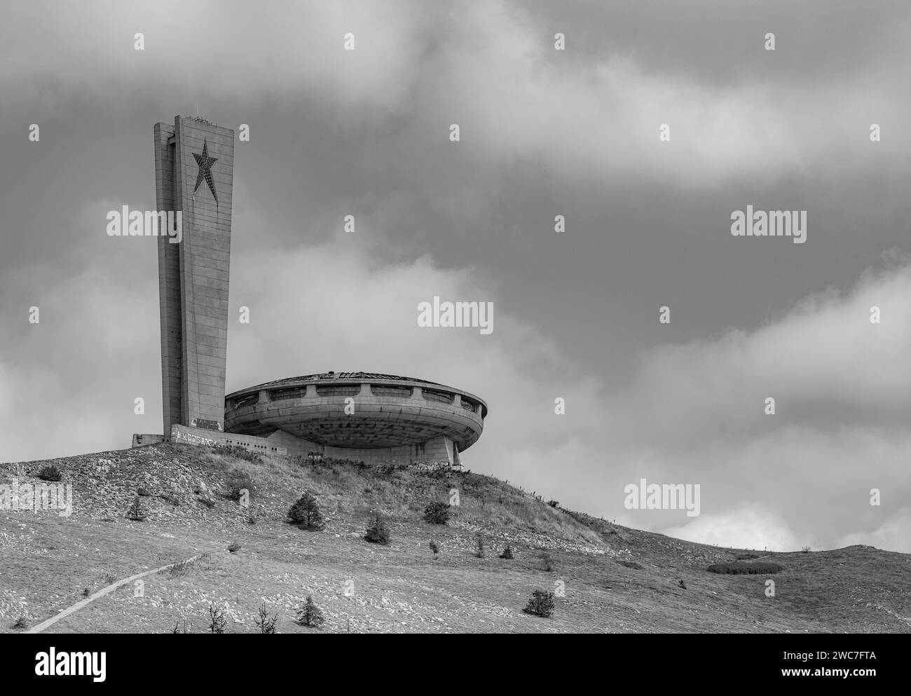 An impressive tower majestically positioned atop a picturesque hill adorned with a natural covering of soil Stock Photo