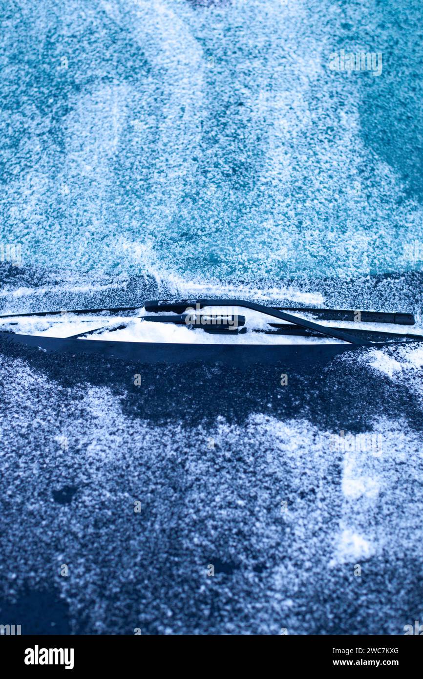 Frozen windshield. Icy windshield, wipers and hood. Winter car difficulties concept. Stock Photo