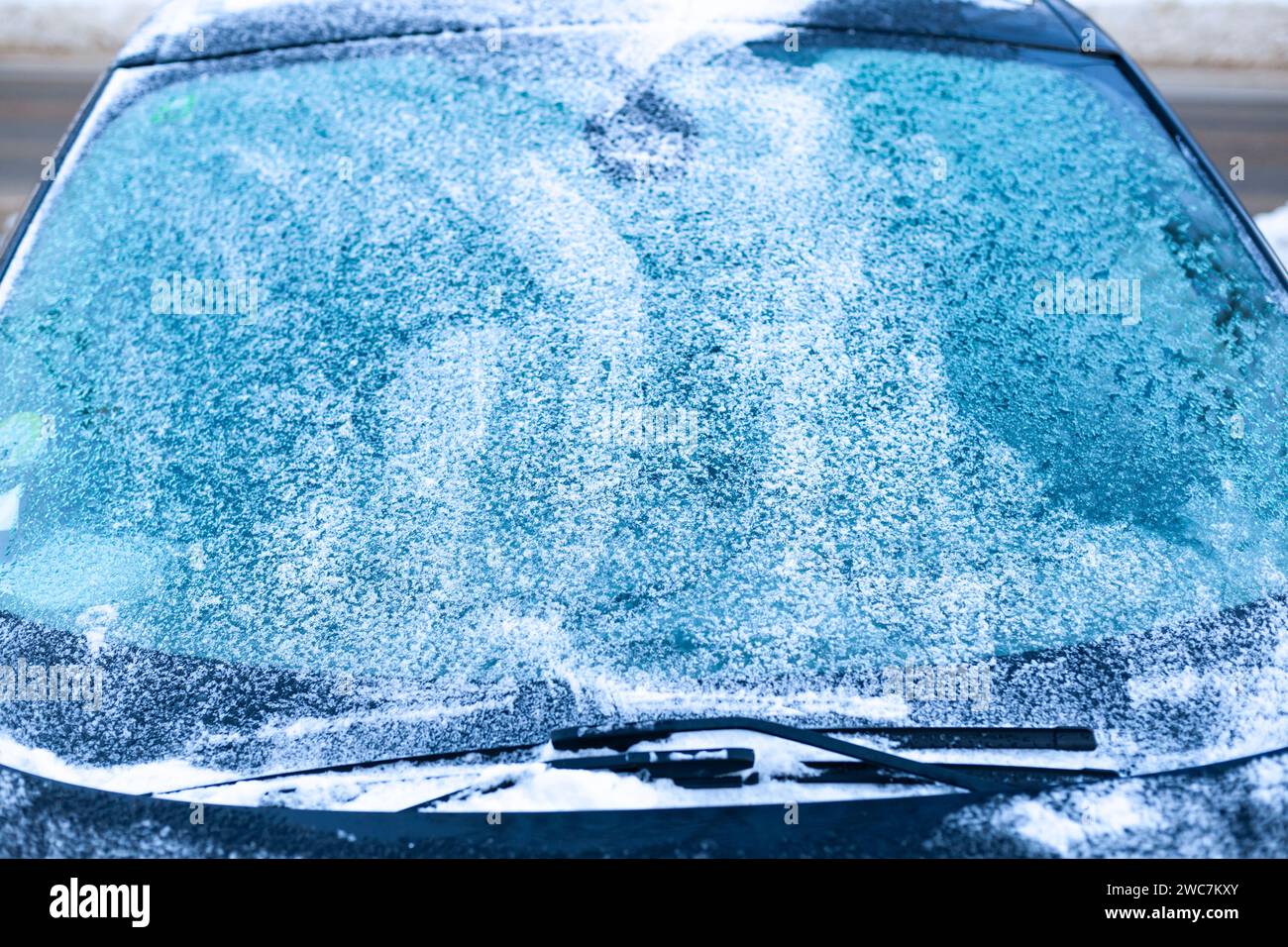 Frozen windshield. Icy windshield, wipers and hood. Winter car difficulties concept Stock Photo