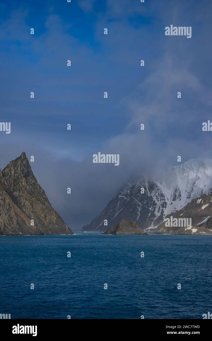 Elephant Island rocky shore and high snow-capped peaks, Cape Lookout, Rowett Island, Mount Pendragon, glaciers and rocky snow-capped peaks, rugged Stock Photo